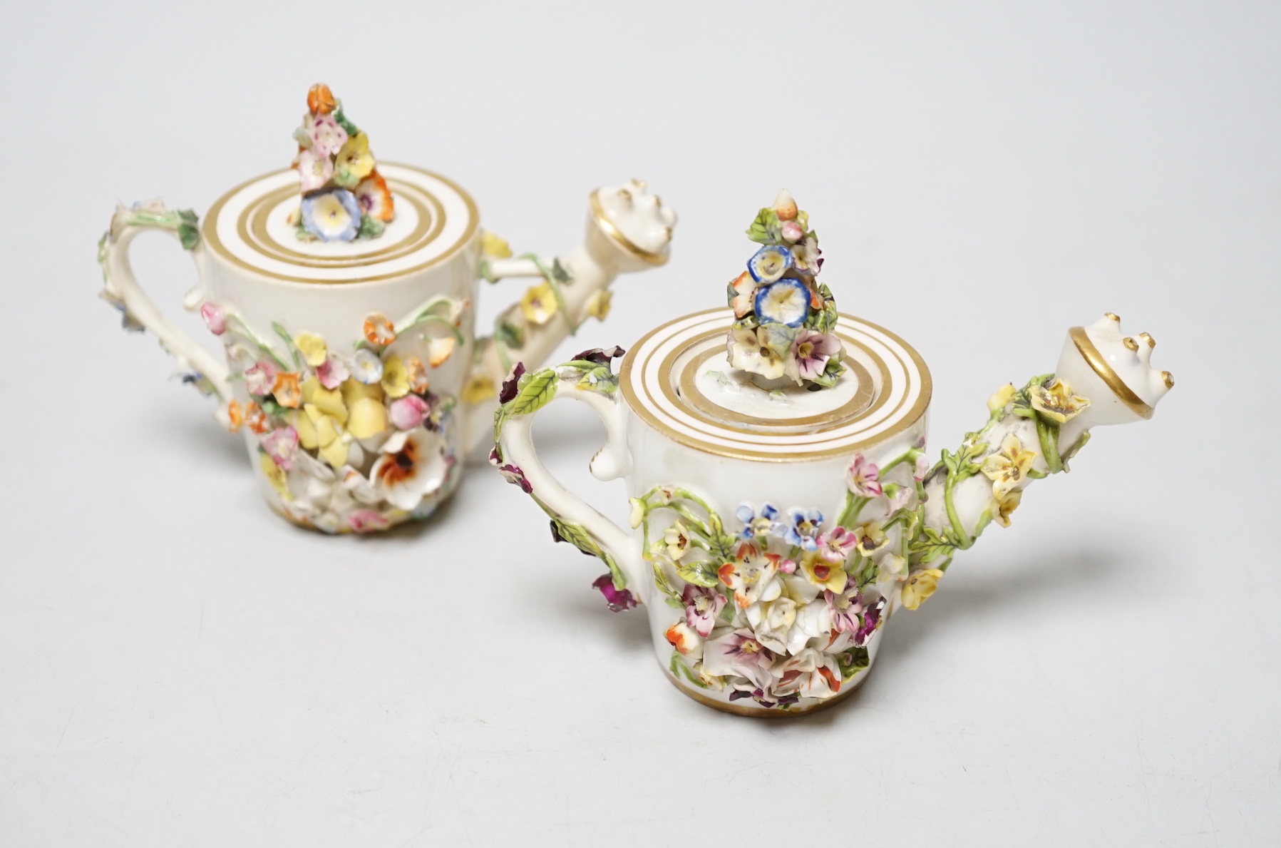 Two Derby porcelain floral encrusted miniature water sprinklers, circa 1825, 9cm high